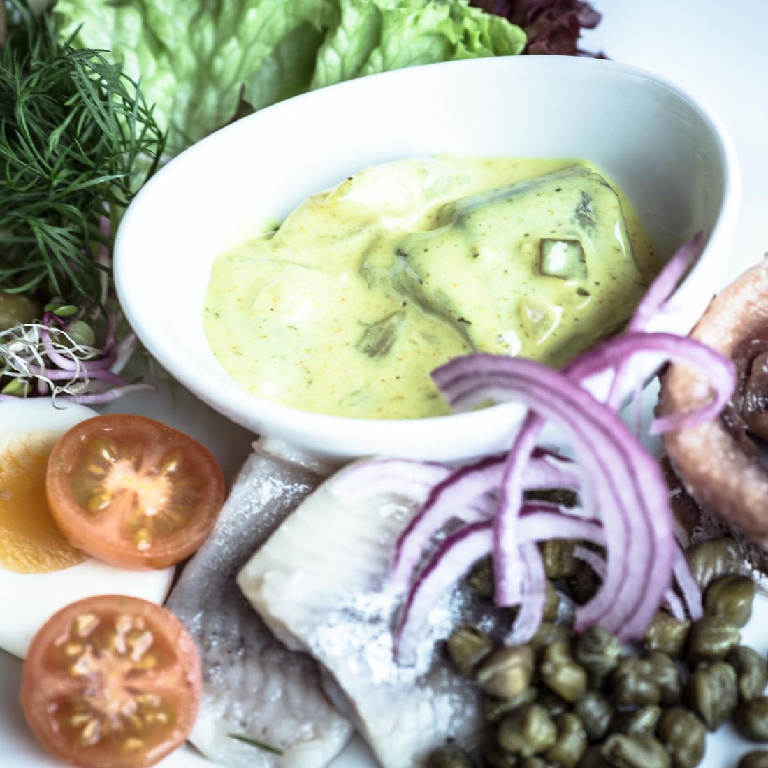 A herring platter presented at Café Klint in Gudhjem Harbor on the island of Bornholm.